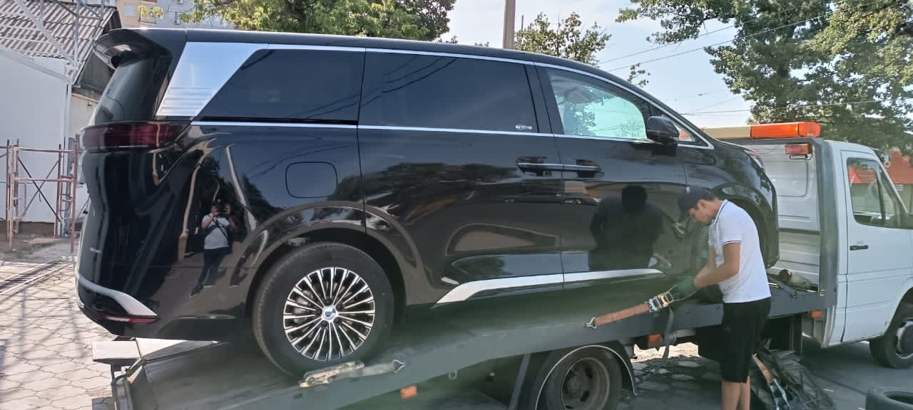 A car from China on a tow truck before shipment to the consignee